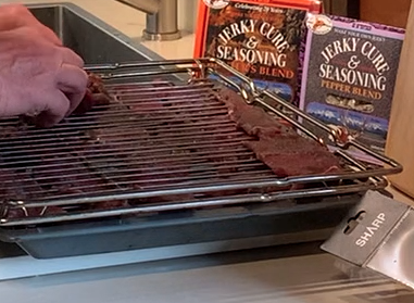 Lay the sliced meat on the racks in a single layer